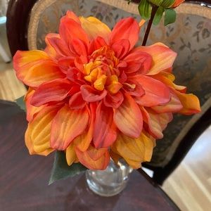 Silk flower stem in a small vase